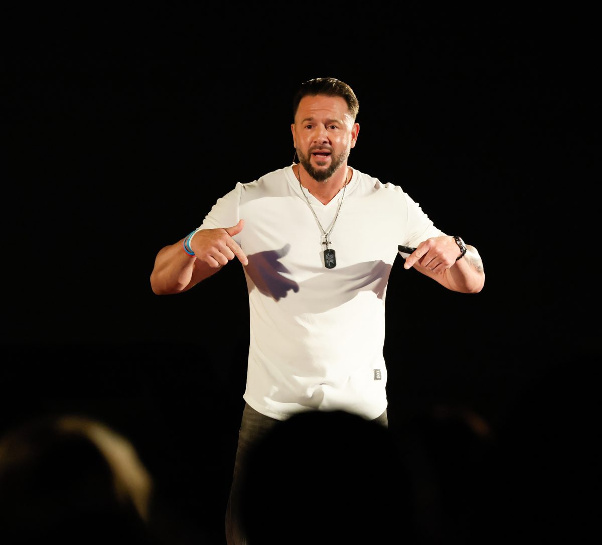 John Kundly on stage, pointing to himself