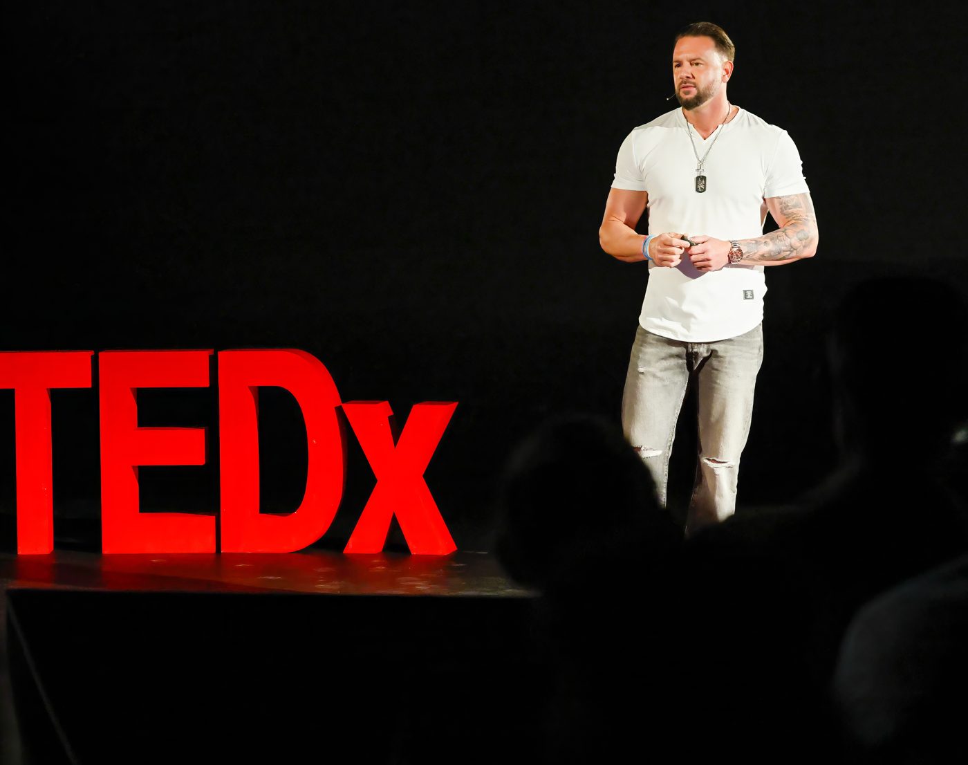 John Kundly beside the TEDx letters